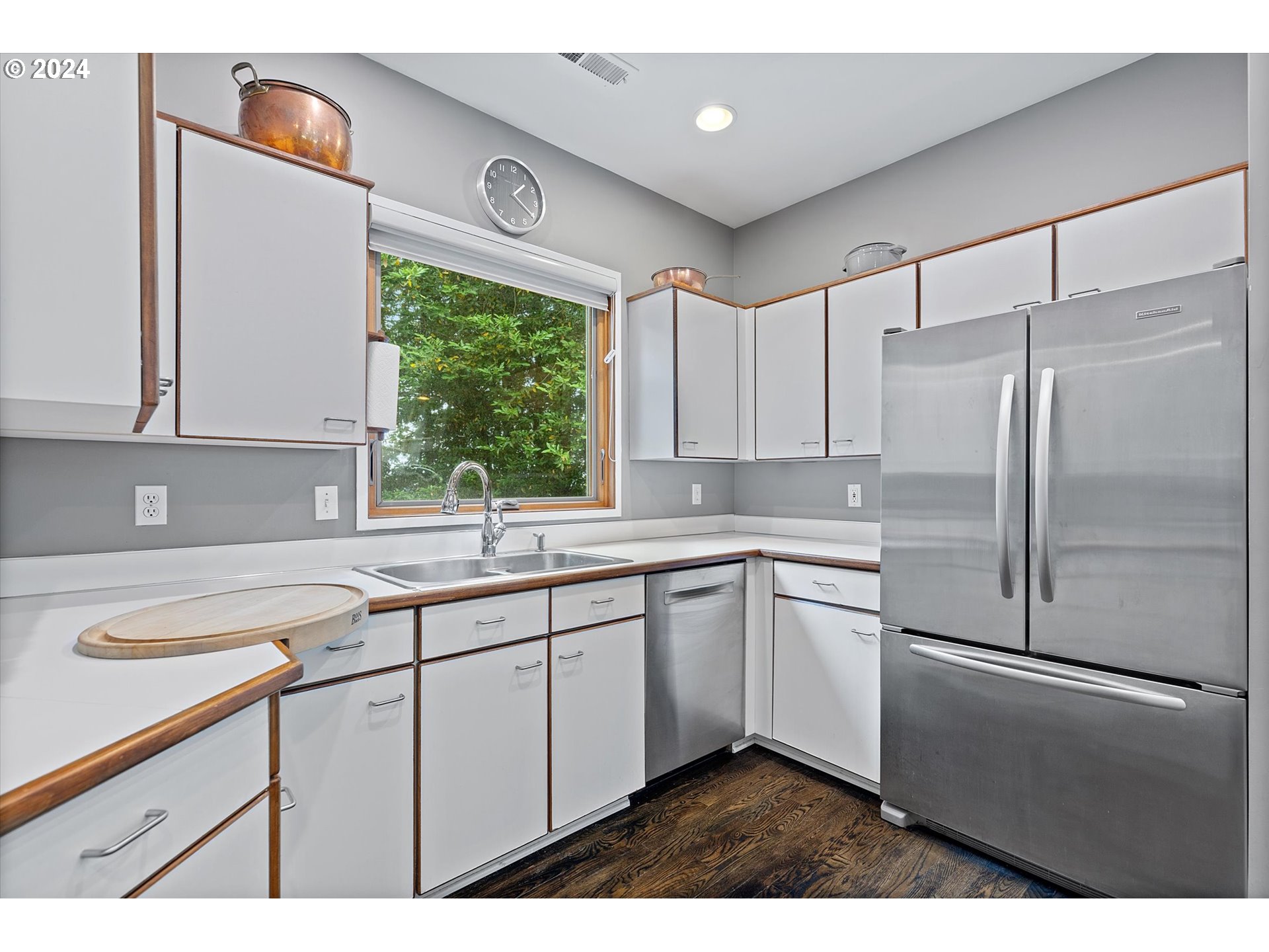 3427 Southwest Dosch Road Portland, OR 97239 - Photo 9 of 48 a kitchen with a sink a refrigerator and cabinets
