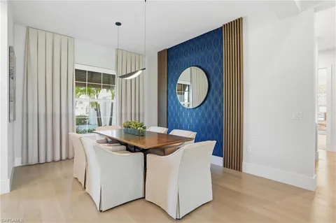 a large white kitchen with a large window and stainless steel appliances