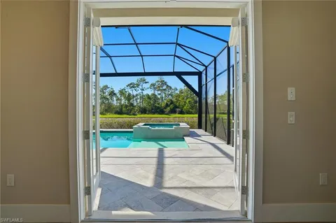 a view of a porch with a floor to ceiling window and yard