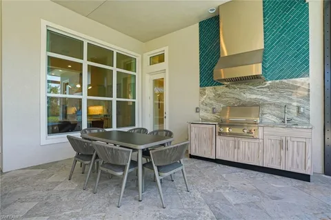 a kitchen with a sink and chairs