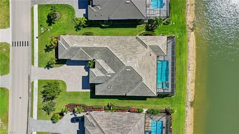 an aerial view of a house with a yard
