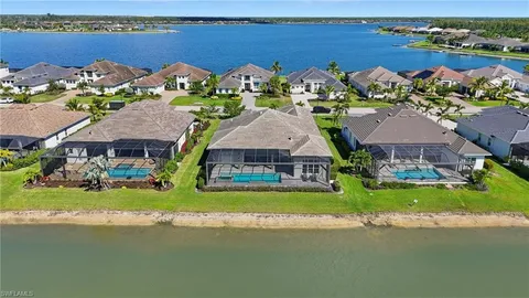 an aerial view of a house with a garden and lake view