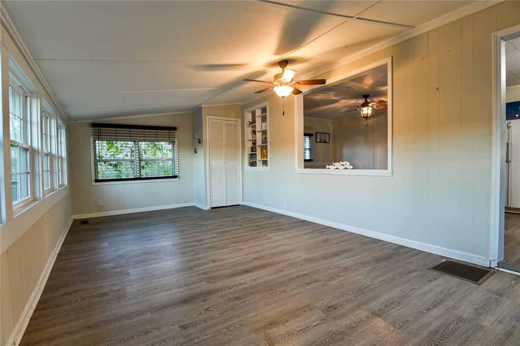 458 Haley Road Jackson, GA 30233 - Photo 7 of 47 an empty room with wooden floor fan and windows