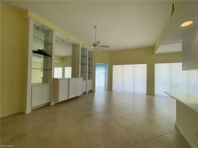 a view of a hallway with furniture and a chandelier