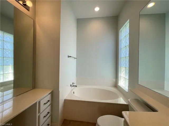 a bathroom with a tub and a sink