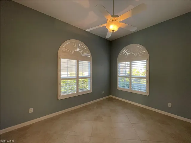 a view of a livingroom with a chandelier fan and a window