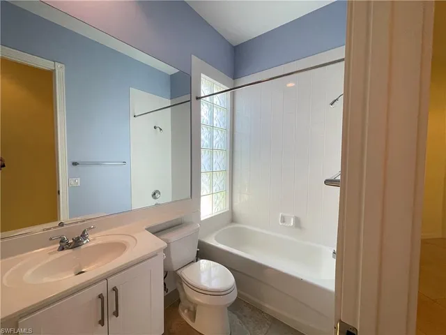 a utility room with stainless steel appliances a sink dishwasher and cabinets