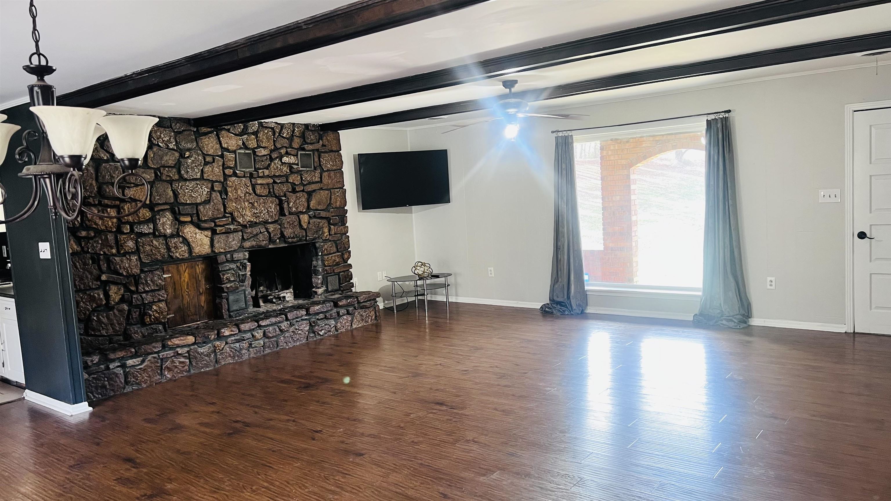 332 Waits Road Burlison, TN 38015 - Photo 15 of 23 a view of a livingroom with wooden floor and a fireplace