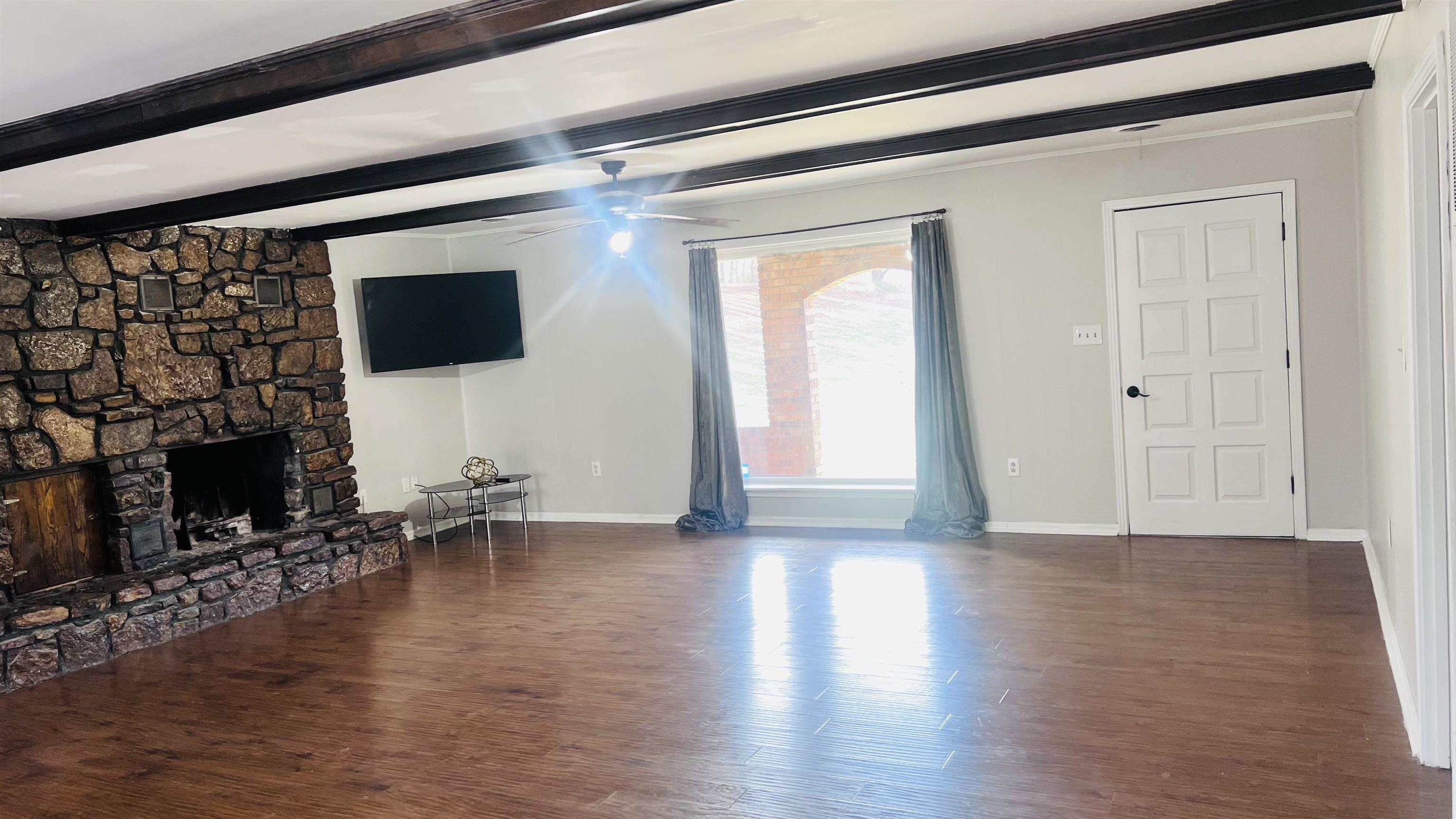 332 Waits Road Burlison, TN 38015 - Photo 16 of 23 a view of a livingroom with furniture a fireplace and wooden floor