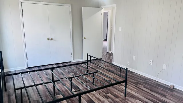 a view of hallway with stairs and wooden floor