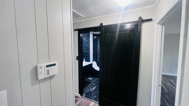 a bathroom with a glass shower door and a sink