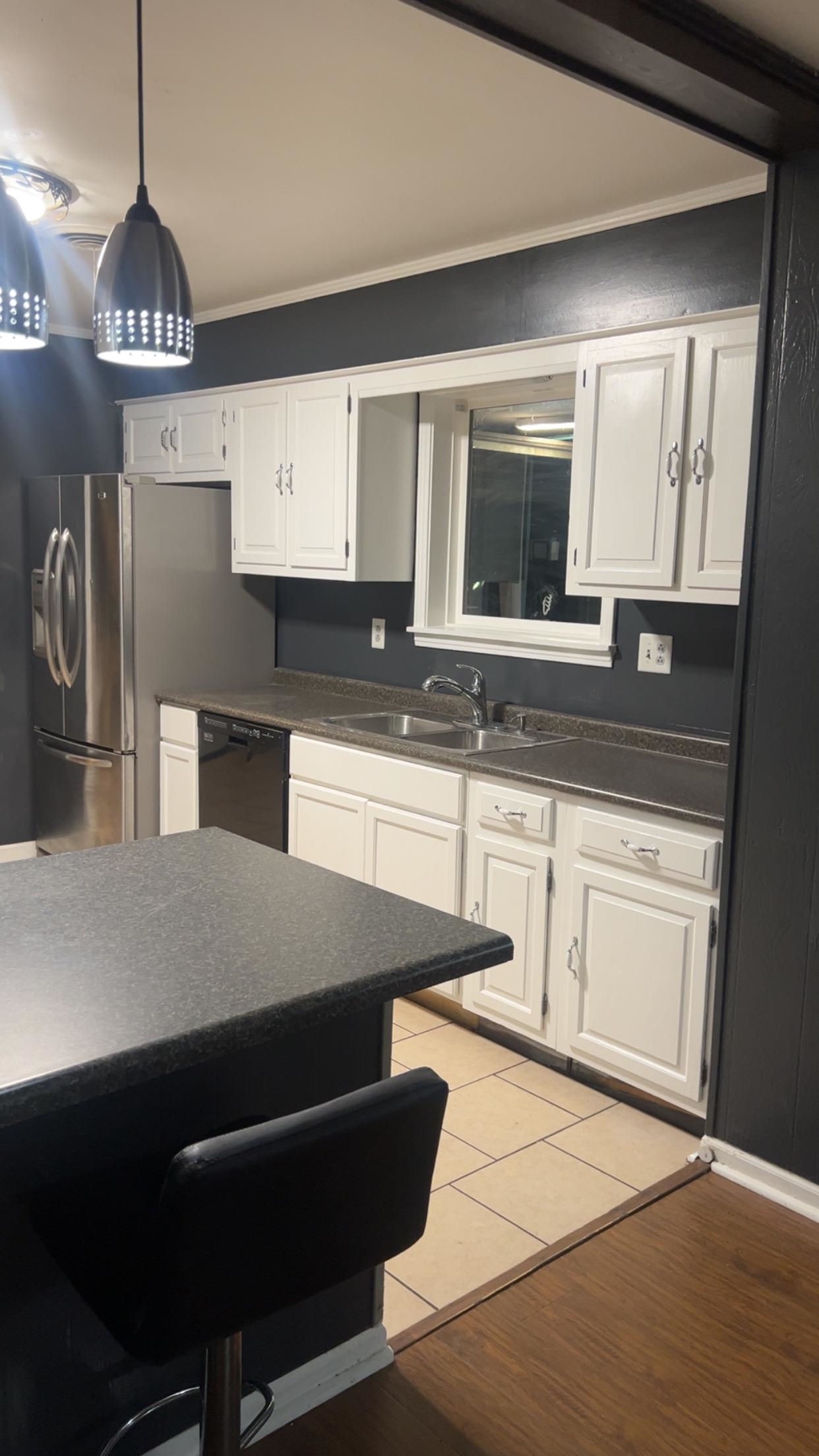 332 Waits Road Burlison, TN 38015 - Photo 10 of 11 a kitchen with kitchen island granite countertop a sink a stove and cabinets