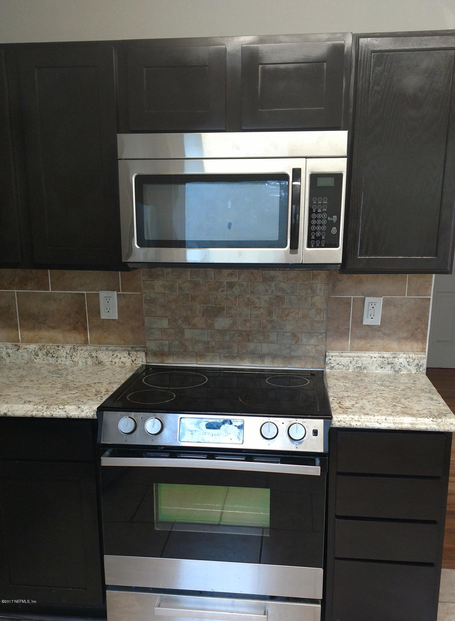 10533 Arendal Road Jacksonville, FL 32218 - Photo 3 of 11 a stove top oven sitting inside of a kitchen