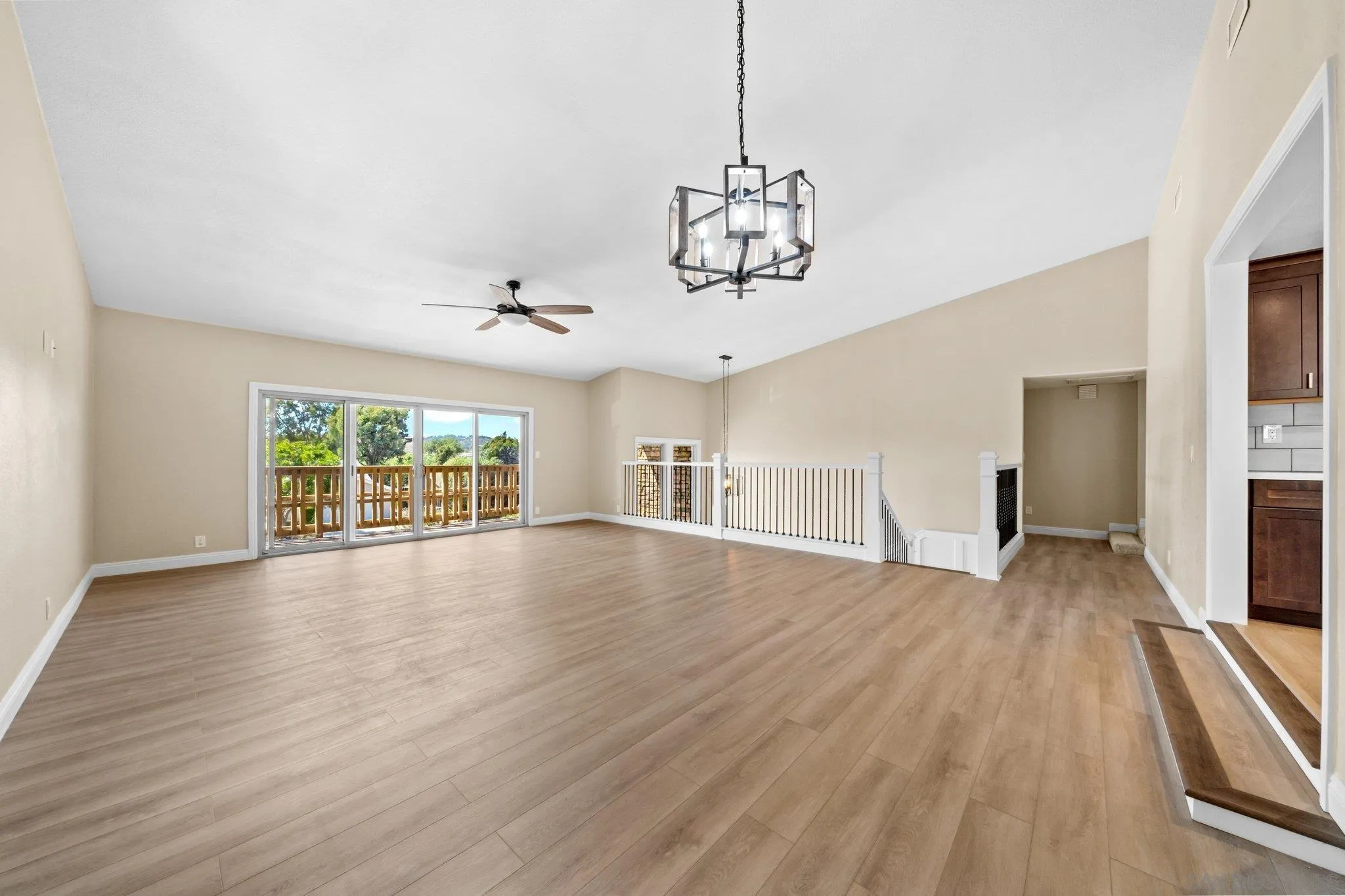 31241 Old River Road Bonsall, CA 92003 - Photo 16 of 51 a view of a livingroom with wooden floor a ceiling fan and windows