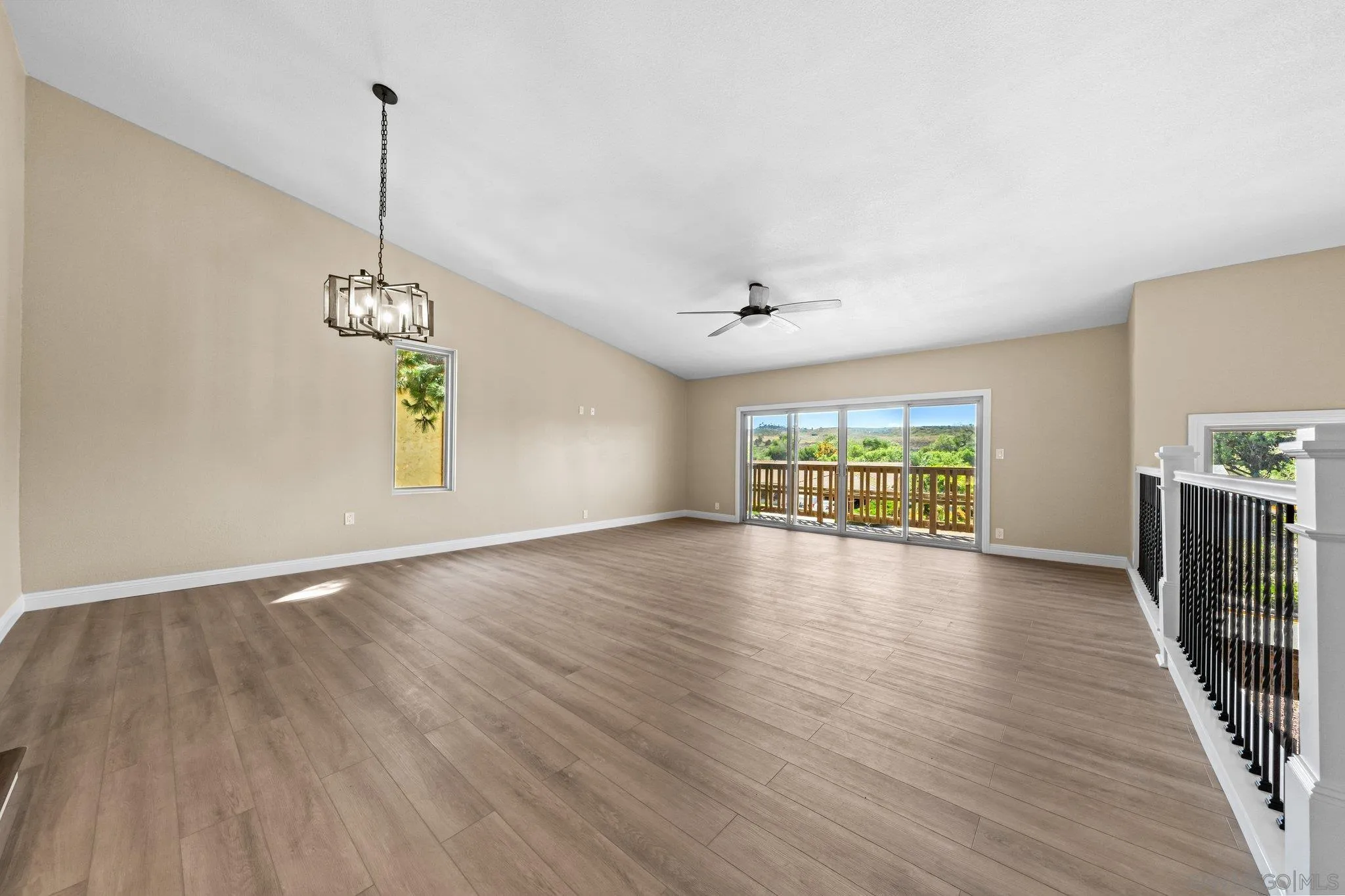 31241 Old River Road Bonsall, CA 92003 - Photo 17 of 51 a view of an empty room with wooden floor and a window