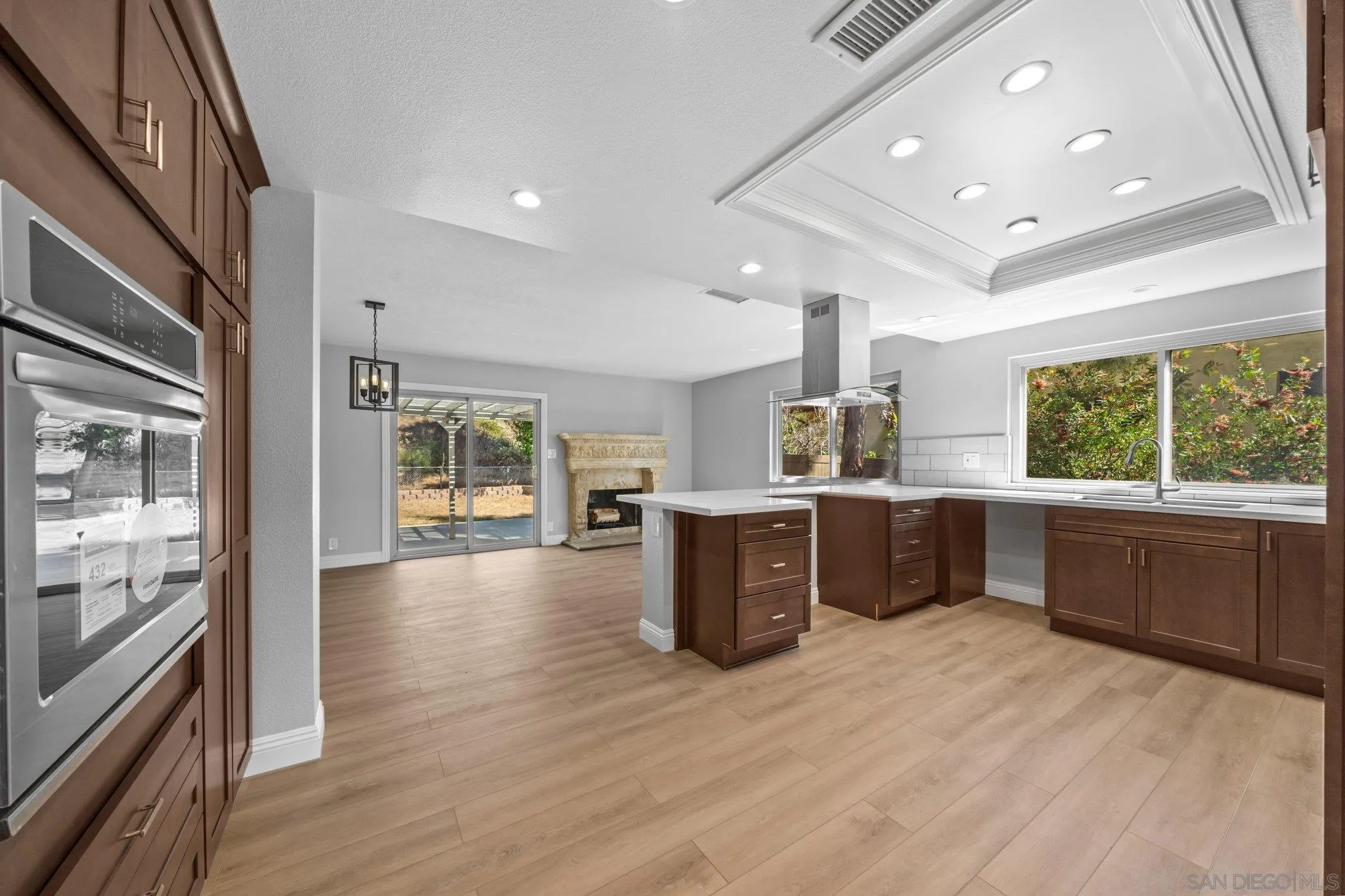 31241 Old River Road Bonsall, CA 92003 - Photo 6 of 51 a large kitchen with stainless steel appliances wooden floors and large window