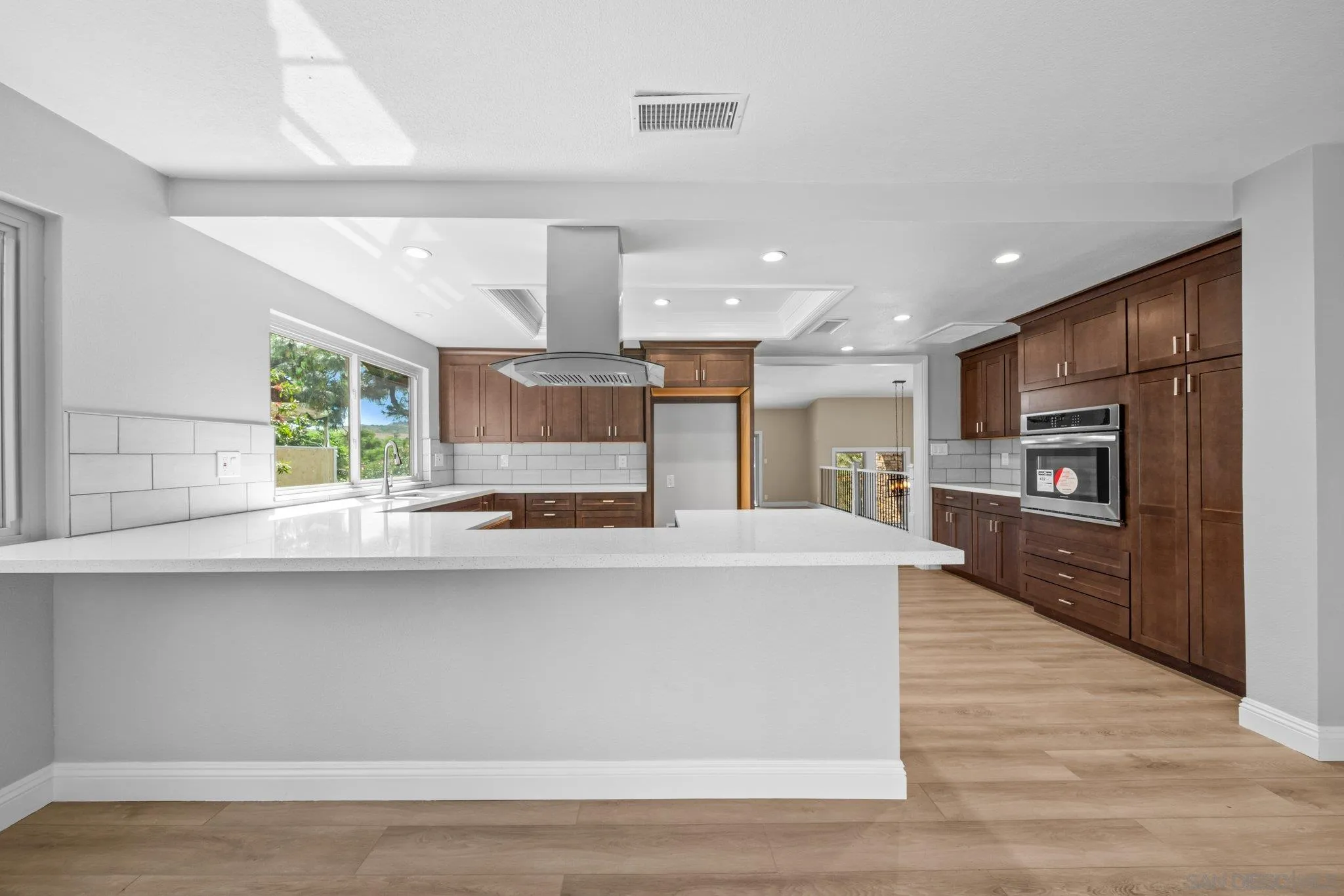 31241 Old River Road Bonsall, CA 92003 - Photo 7 of 51 a large kitchen with stainless steel appliances a large counter top a stove and a refrigerator