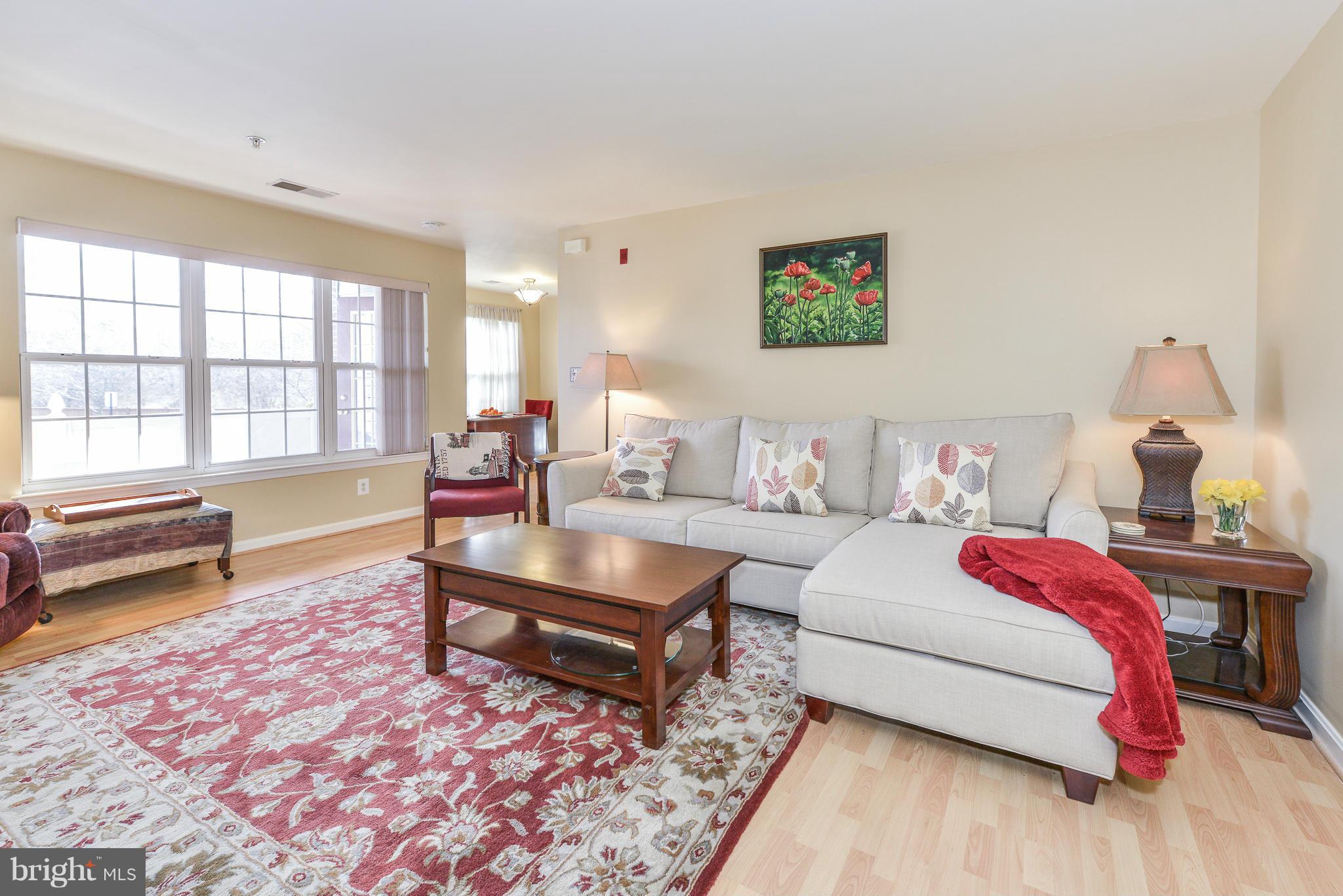 511 Constellation Square Southeast, Unit A Leesburg, VA 20175 - Photo 2 of 27 a living room with furniture and a wooden floor