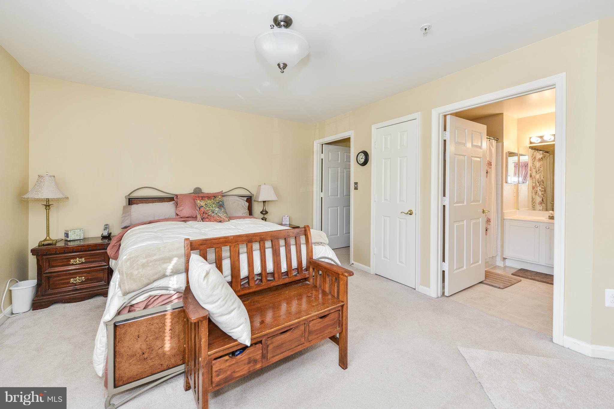 511 Constellation Square Southeast, Unit A Leesburg, VA 20175 - Photo 11 of 27 a bedroom with a bed and a cabinets