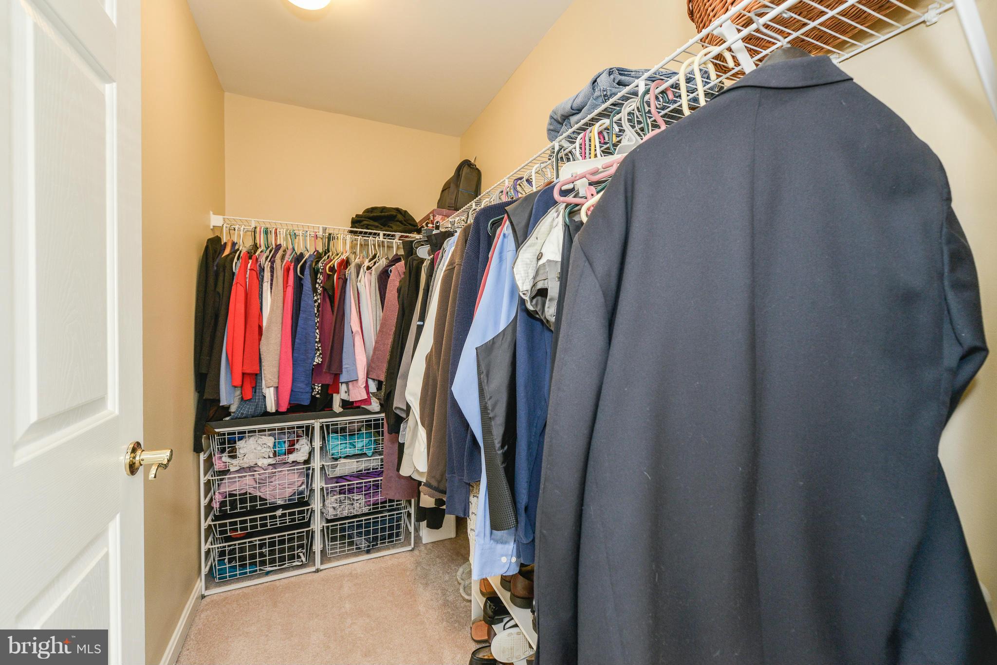 511 Constellation Square Southeast, Unit A Leesburg, VA 20175 - Photo 12 of 27 a view of walk in closet with clothes and shoes