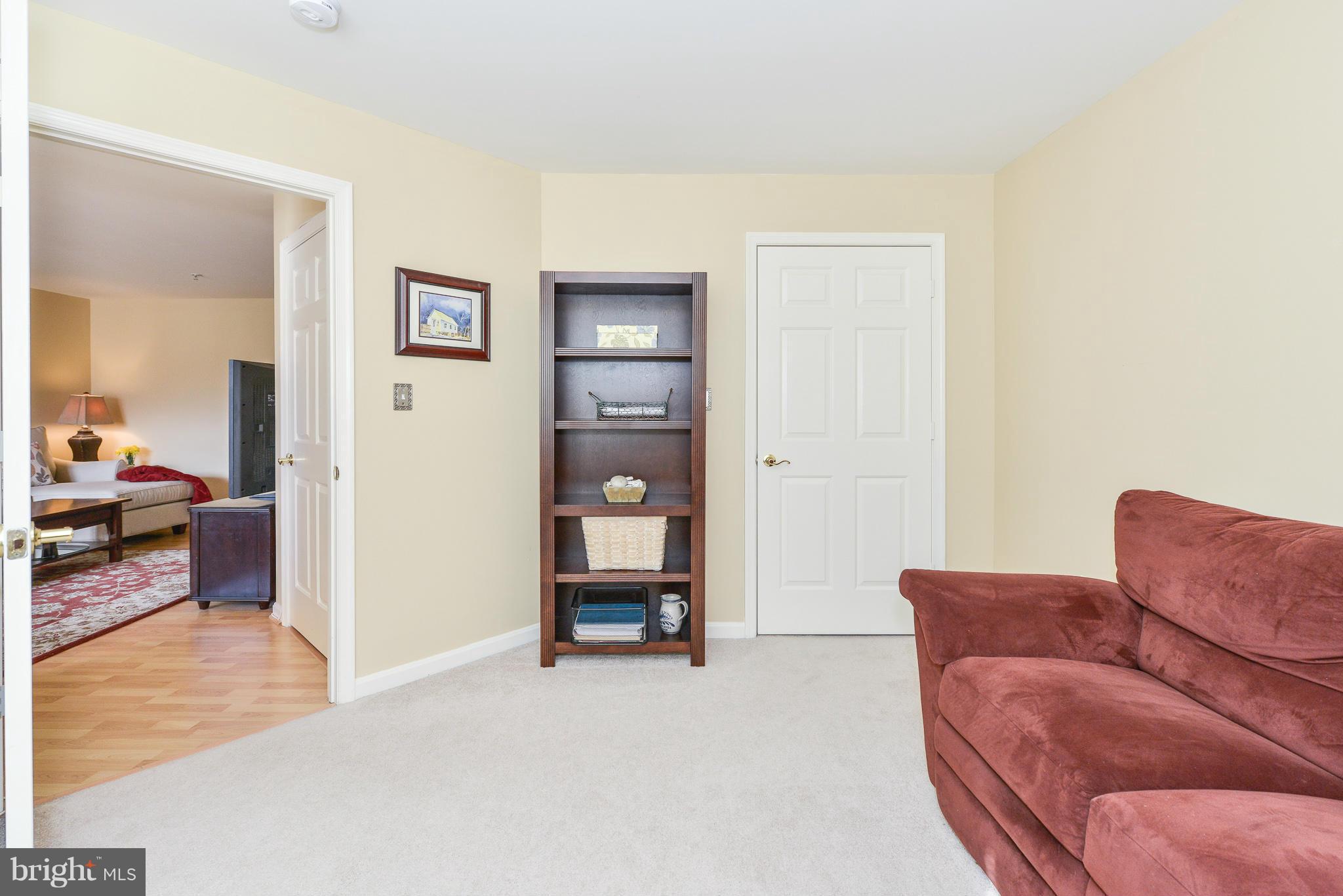 511 Constellation Square Southeast, Unit A Leesburg, VA 20175 - Photo 15 of 27 a living room with a couch and a view of en suite bathroom