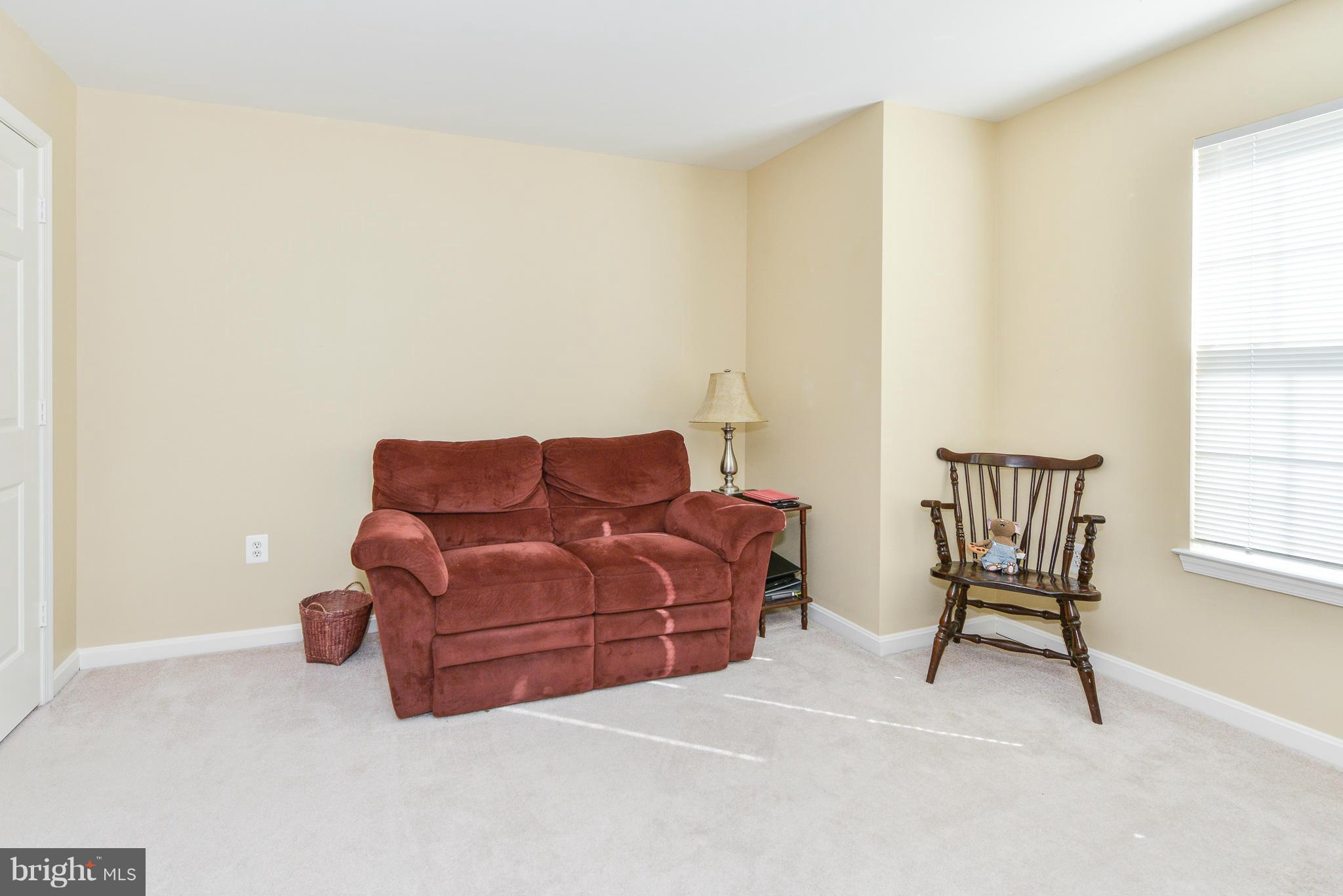 511 Constellation Square Southeast, Unit A Leesburg, VA 20175 - Photo 16 of 27 a living room with furniture and a window