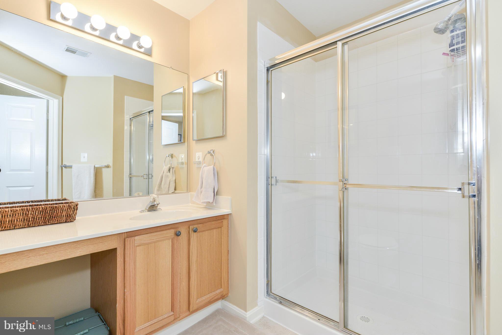 511 Constellation Square Southeast, Unit A Leesburg, VA 20175 - Photo 17 of 27 a bathroom with a double vanity sink and mirror