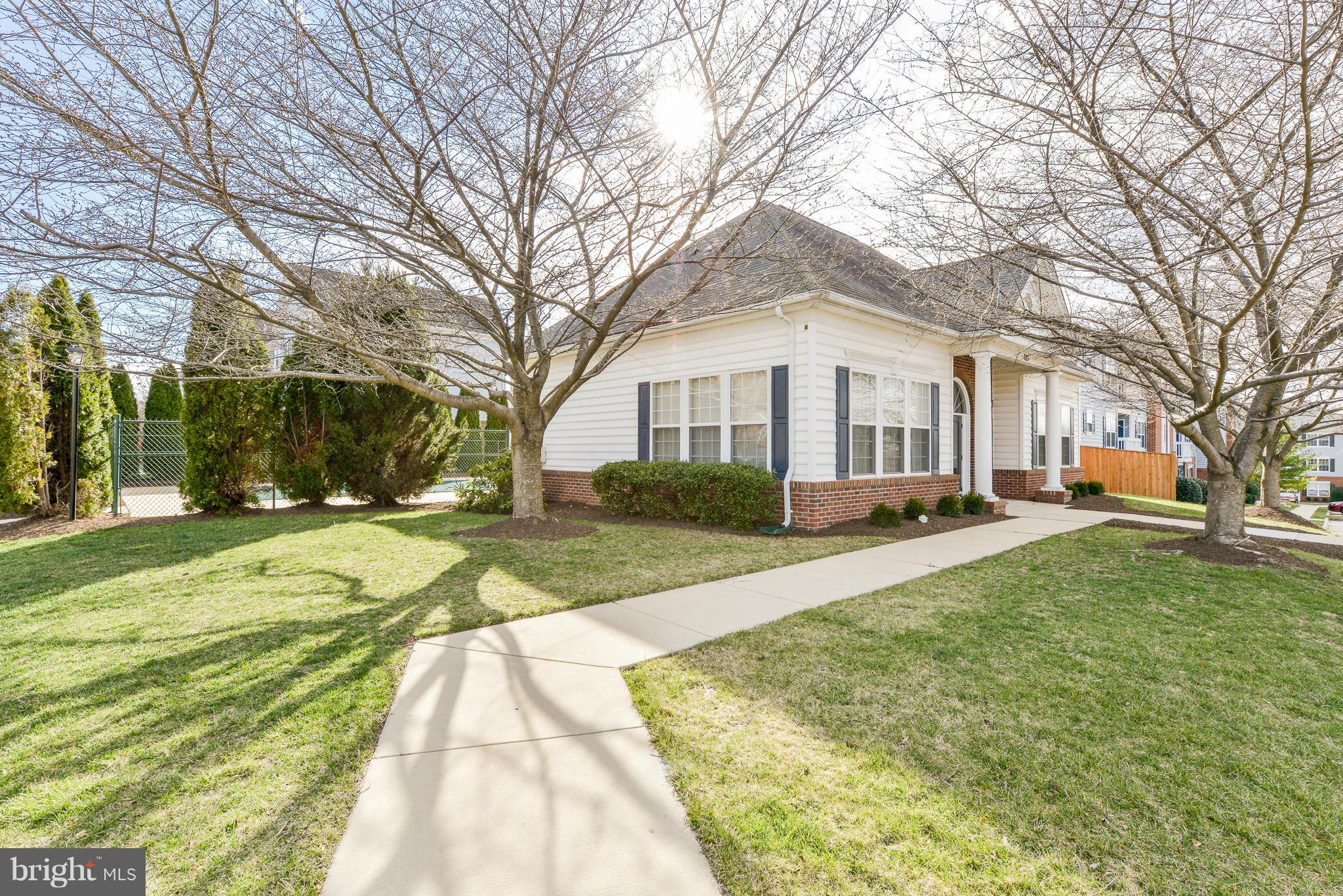 511 Constellation Square Southeast, Unit A Leesburg, VA 20175 - Photo 21 of 27 a view of a white house with a large trees