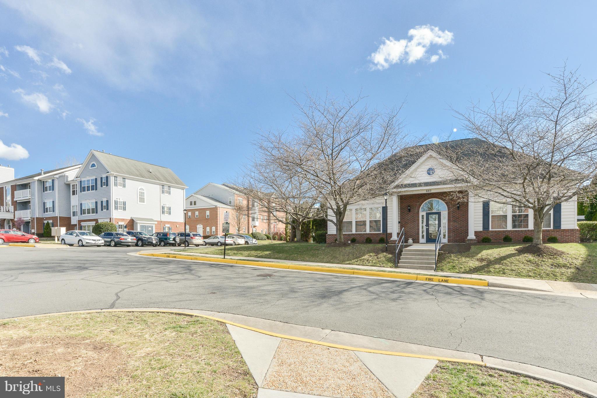 511 Constellation Square Southeast, Unit A Leesburg, VA 20175 - Photo 22 of 27 a view of a white house with a swimming pool and a yard