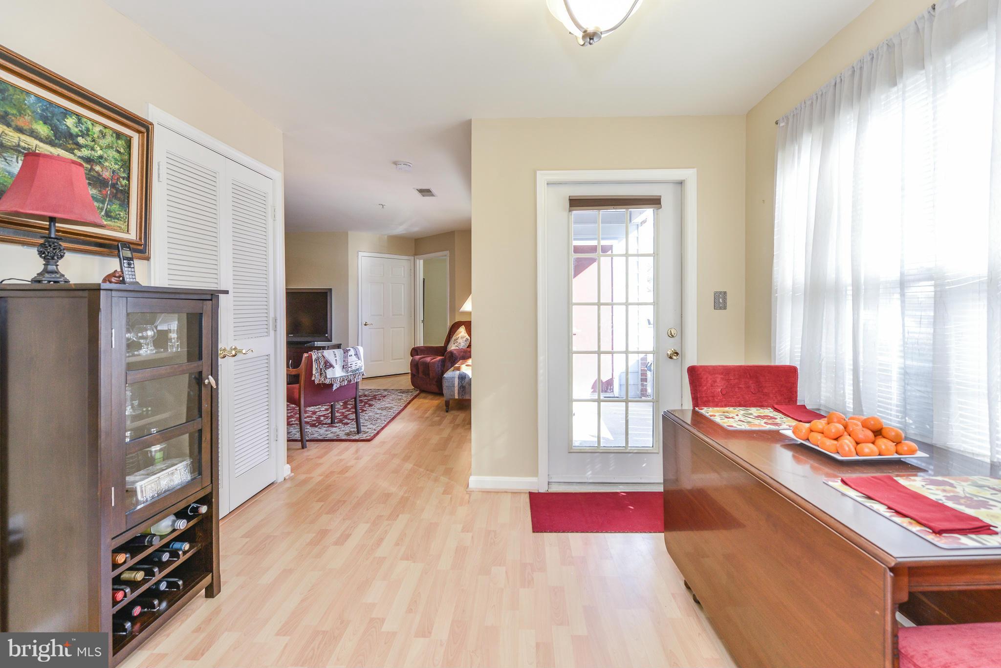 511 Constellation Square Southeast, Unit A Leesburg, VA 20175 - Photo 23 of 27 a living room with furniture and a flat screen tv