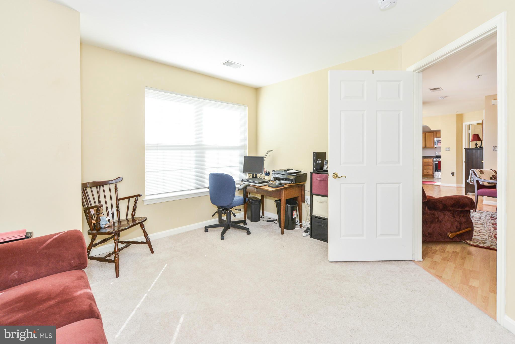511 Constellation Square Southeast, Unit A Leesburg, VA 20175 - Photo 27 of 27 a view of a livingroom with workspace and a couch