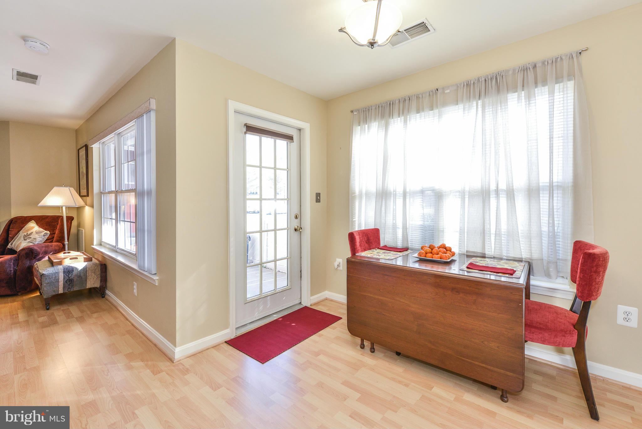 511 Constellation Square Southeast, Unit A Leesburg, VA 20175 - Photo 4 of 27 a living room with furniture and a large window