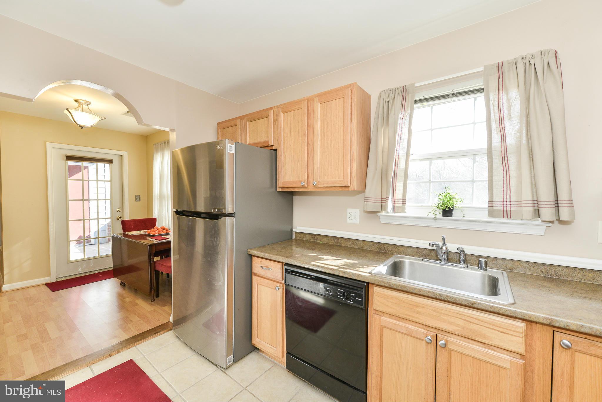 511 Constellation Square Southeast, Unit A Leesburg, VA 20175 - Photo 8 of 27 a kitchen with a sink a refrigerator and cabinets
