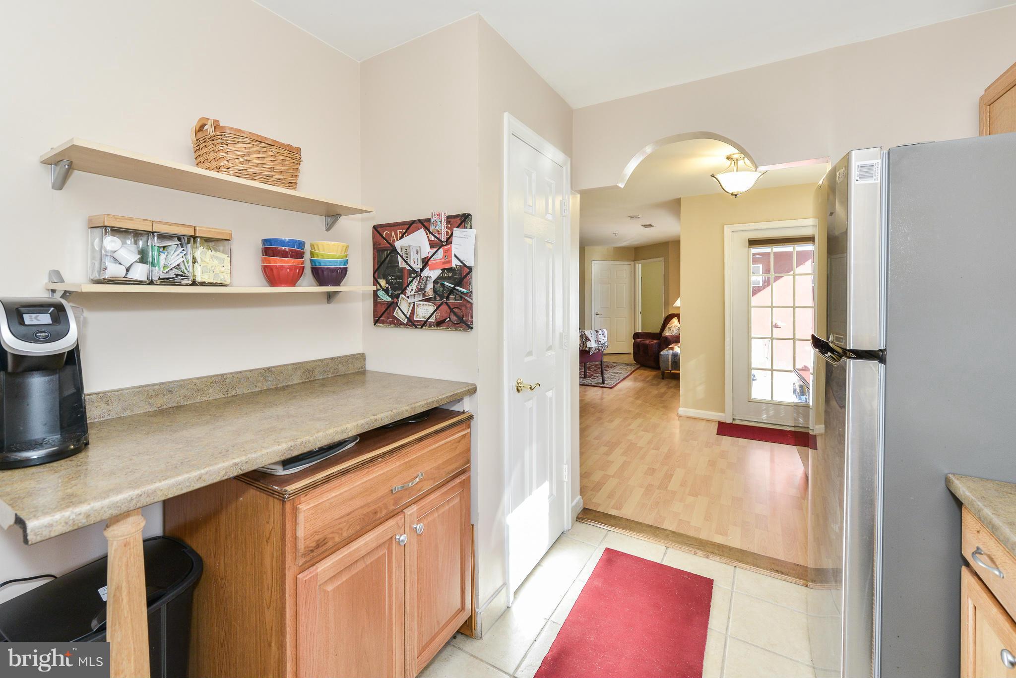 511 Constellation Square Southeast, Unit A Leesburg, VA 20175 - Photo 9 of 27 a view of a kitchen with fridge and wooden floor