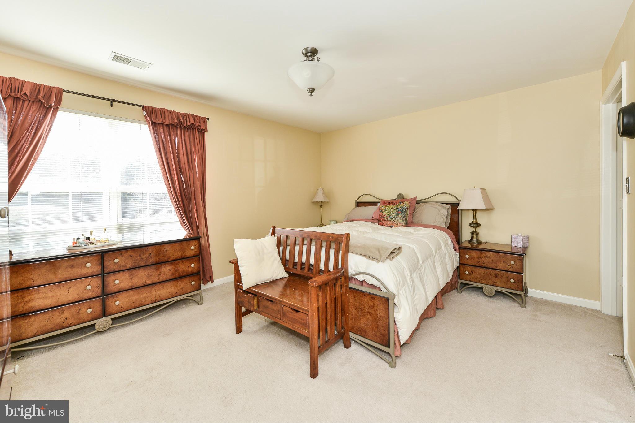 511 Constellation Square Southeast, Unit A Leesburg, VA 20175 - Photo 10 of 27 a bedroom with a bed and a large window