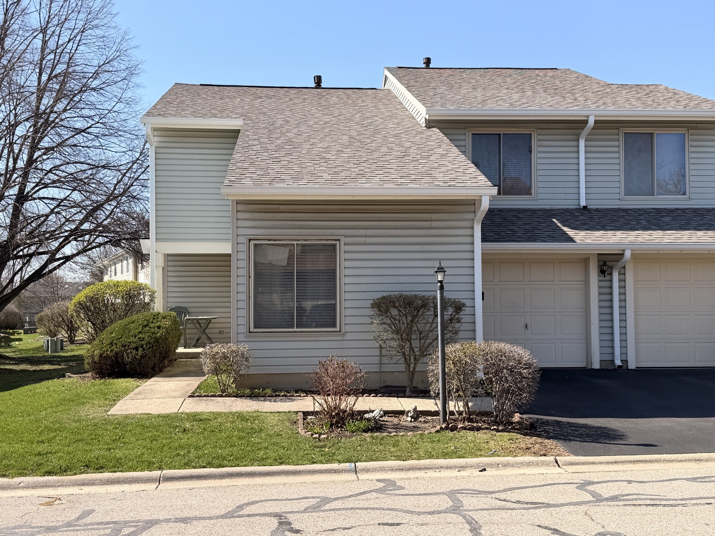 772 Colorado Court, Unit 772 Carol Stream, IL 60188 - Photo 1 of 26 a front view of a house with a yard and garage