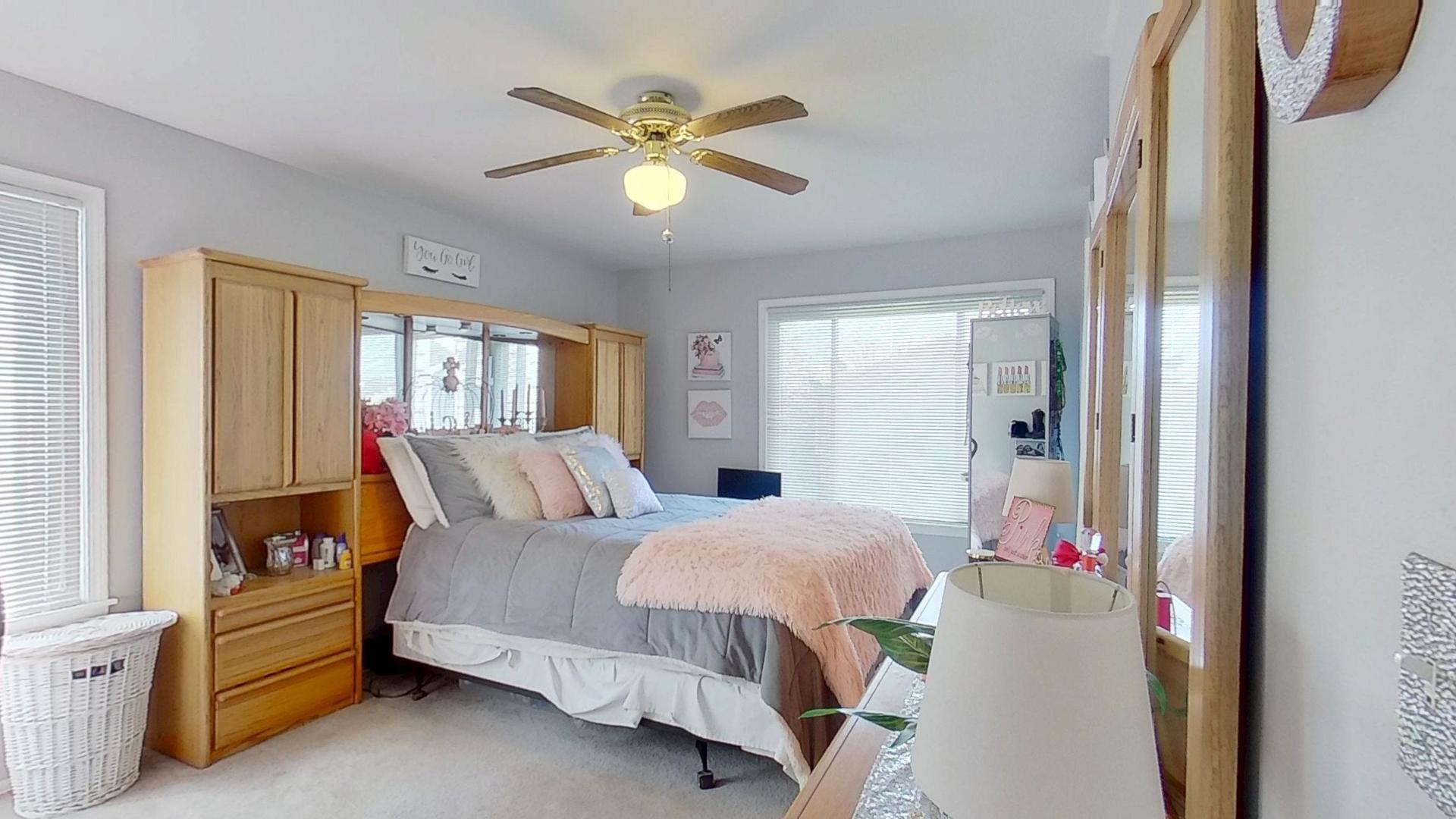 772 Colorado Court, Unit 772 Carol Stream, IL 60188 - Photo 16 of 26 a bedroom with a bed and a chandelier