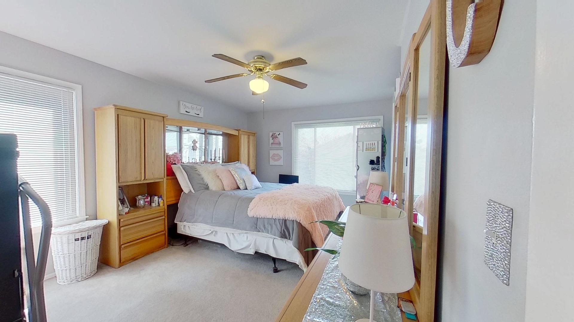 772 Colorado Court, Unit 772 Carol Stream, IL 60188 - Photo 17 of 26 a bedroom with a bed closet and a window