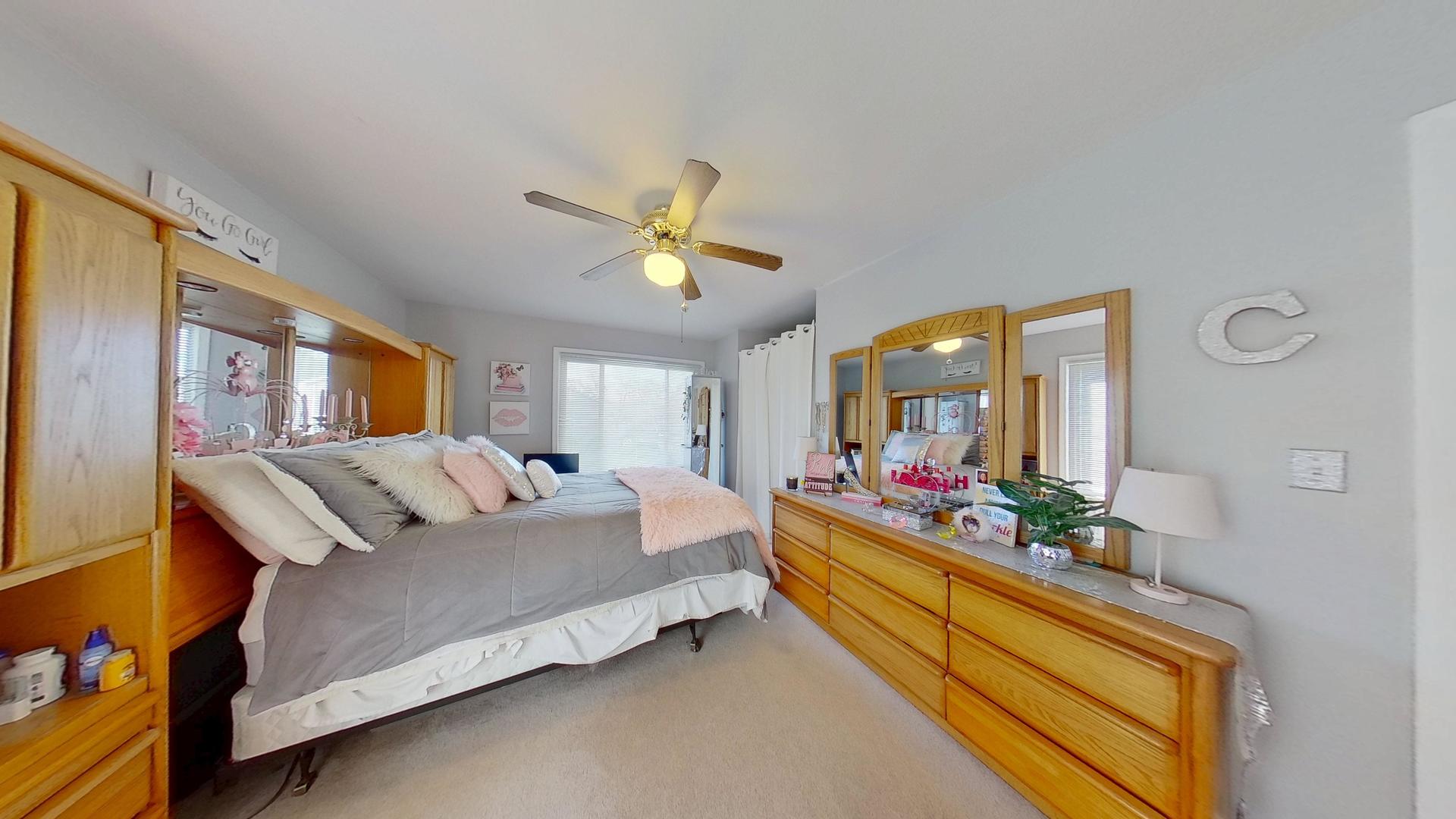 772 Colorado Court, Unit 772 Carol Stream, IL 60188 - Photo 18 of 26 a bedroom with a bed window and couch