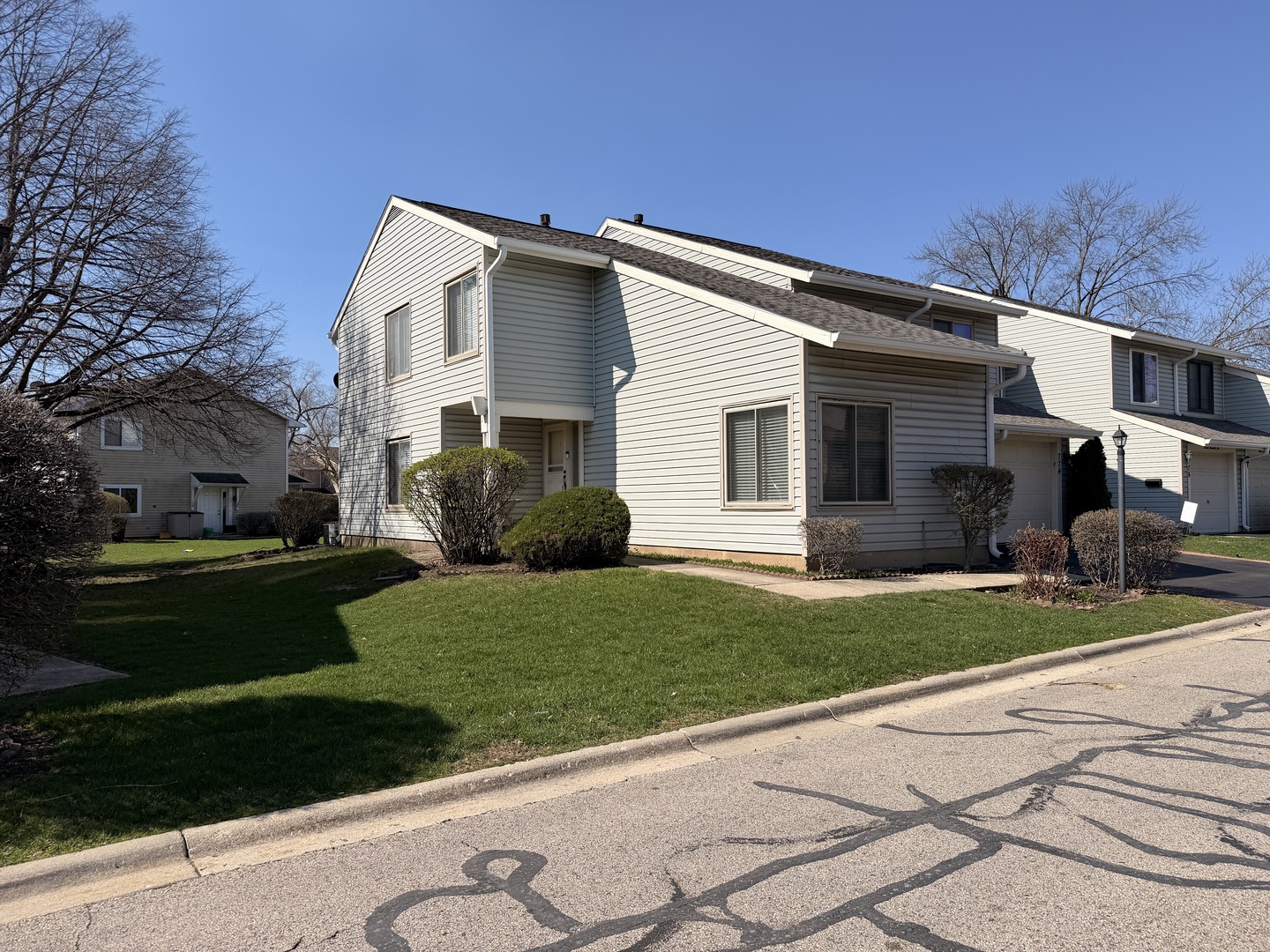 772 Colorado Court, Unit 772 Carol Stream, IL 60188 - Photo 2 of 26 a front view of a house with a garden and yard