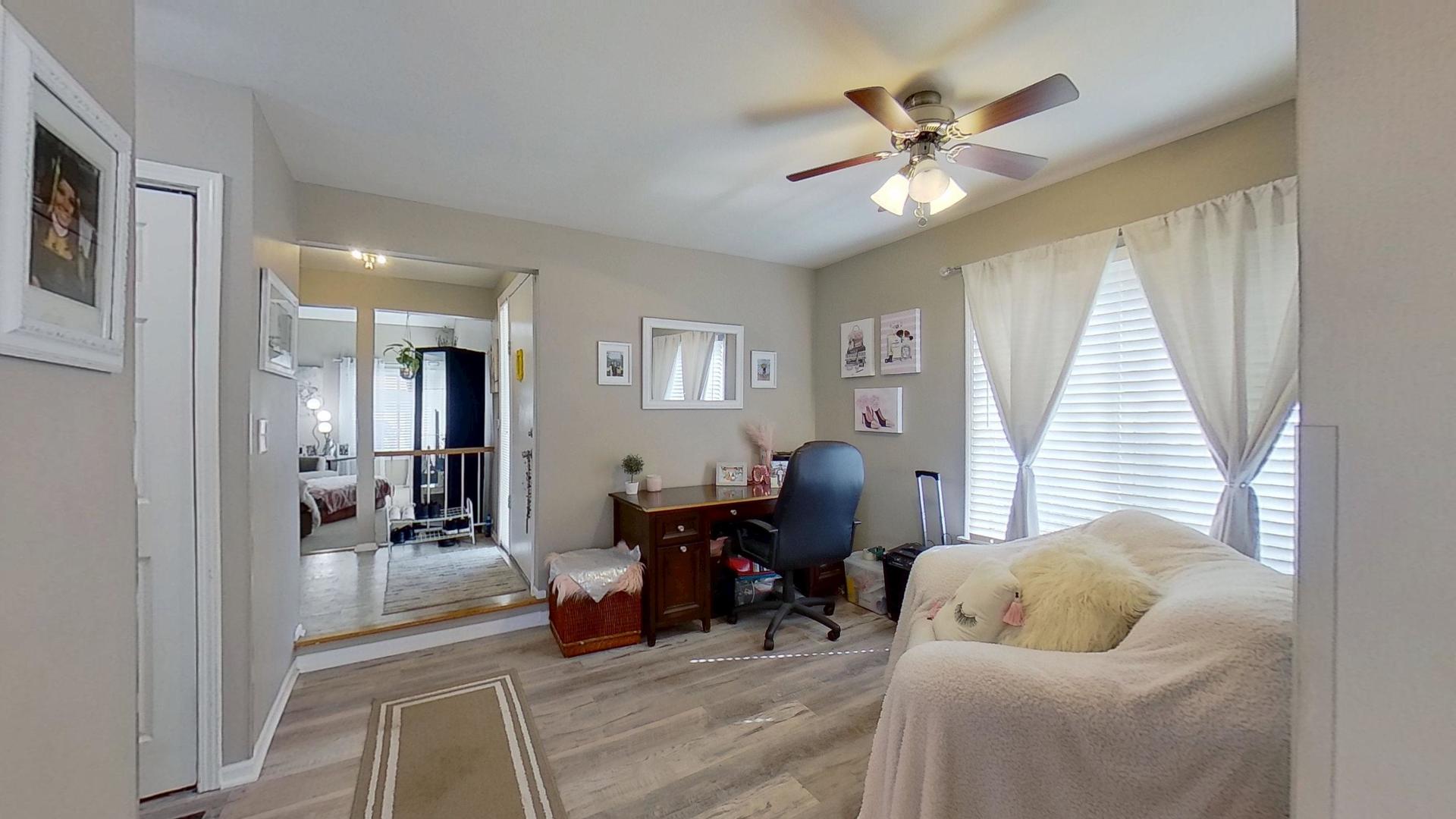 772 Colorado Court, Unit 772 Carol Stream, IL 60188 - Photo 5 of 26 a living room with furniture and a chandelier