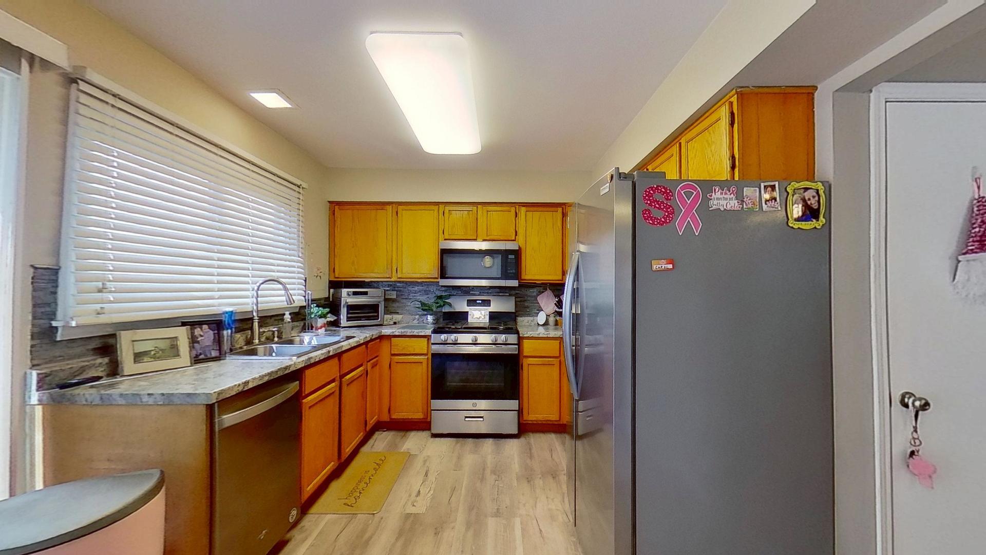 772 Colorado Court, Unit 772 Carol Stream, IL 60188 - Photo 7 of 26 a kitchen with a sink appliances cabinets and a window