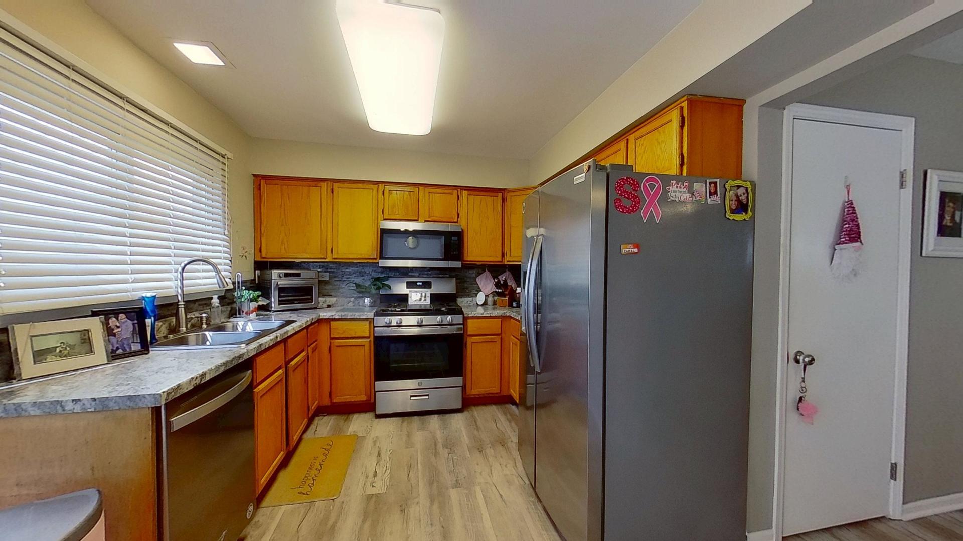 772 Colorado Court, Unit 772 Carol Stream, IL 60188 - Photo 8 of 26 a kitchen with stainless steel appliances granite countertop a refrigerator sink and stove