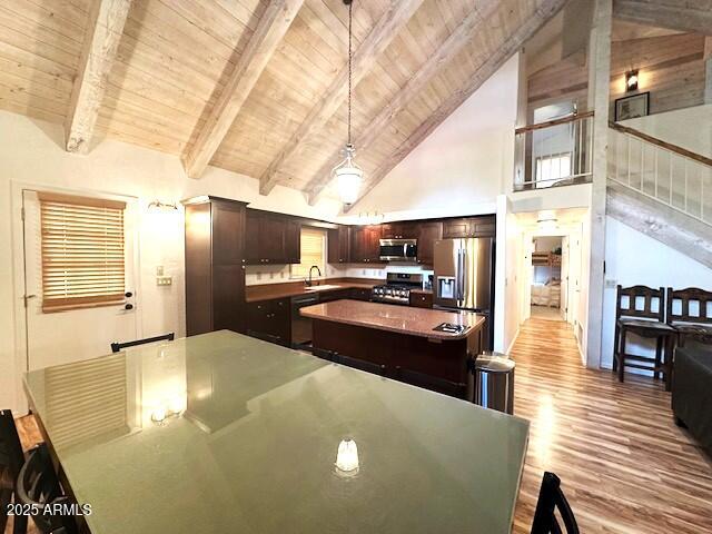 207 Blue Ridge Road Mormon Lake, AZ 86038 - Photo 23 of 66 a kitchen with stainless steel appliances a stove a refrigerator a sink a dining table and chairs with wooden floor