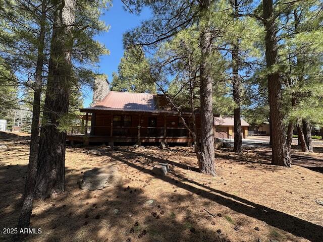 207 Blue Ridge Road Mormon Lake, AZ 86038 - Photo 3 of 66 a view of house with snow on the road