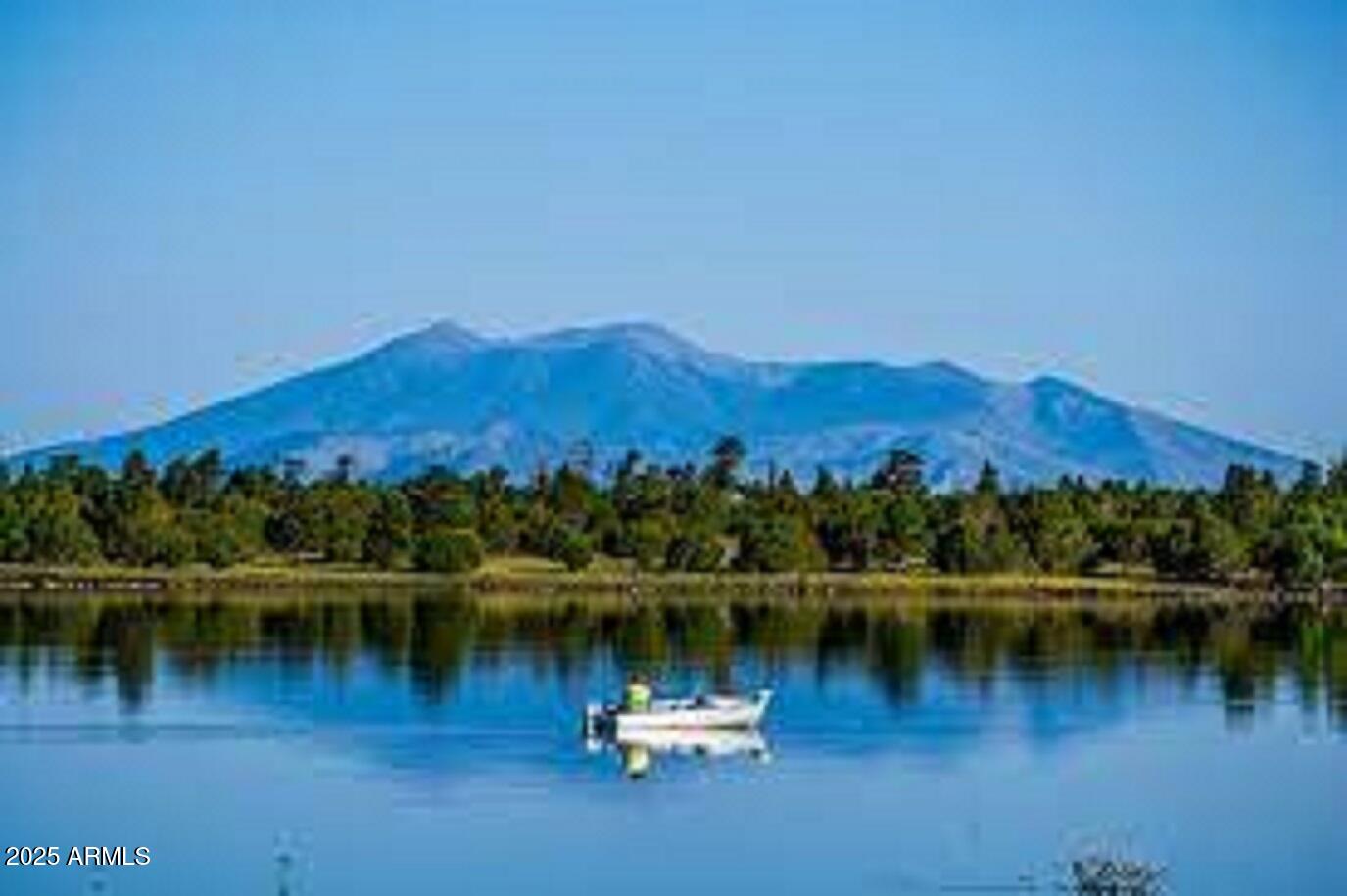 207 Blue Ridge Road Mormon Lake, AZ 86038 - Photo 62 of 66 a view of a lake with a mountain in the background