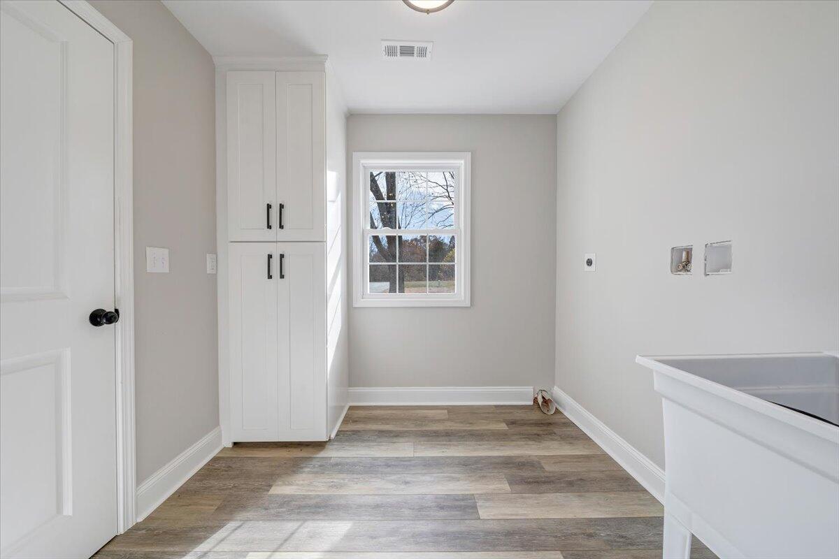 149 Windlass Road Moneta, VA 24121 - Photo 13 of 44 a view of an empty room with wooden floor and a window