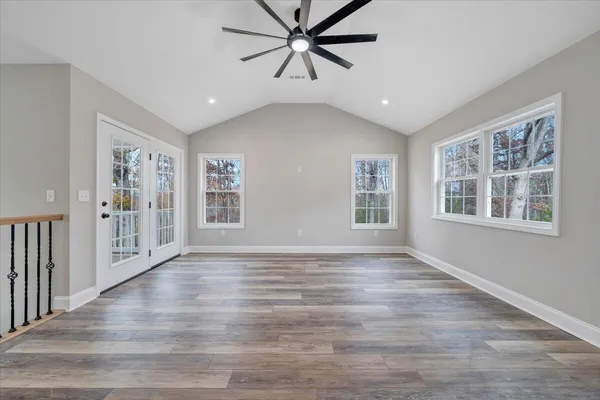 wooden floor in an empty room with a window
