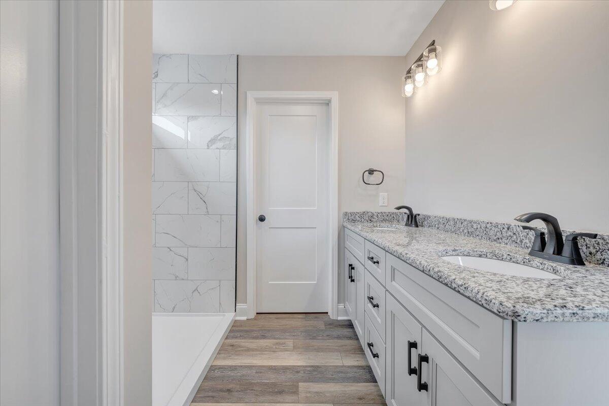 149 Windlass Road Moneta, VA 24121 - Photo 20 of 44 a spacious bathroom with a granite countertop sink a mirror and shower