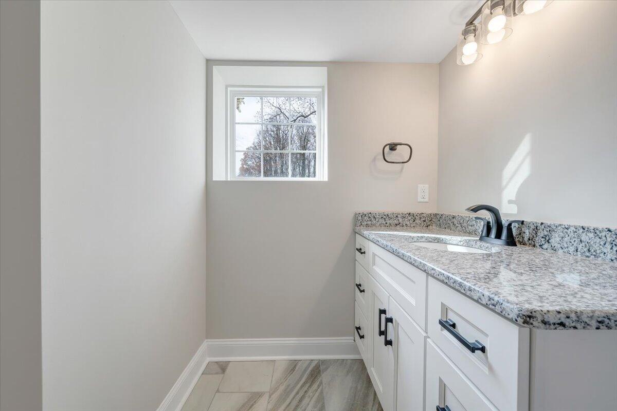 149 Windlass Road Moneta, VA 24121 - Photo 29 of 44 a bathroom with a granite countertop sink and a mirror
